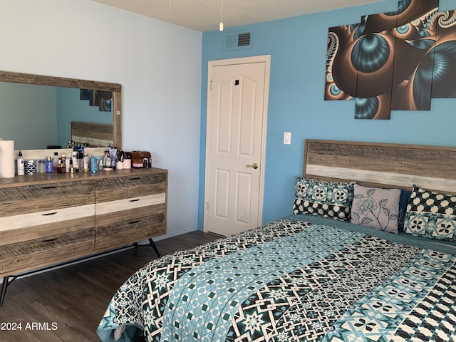 bedroom with dark hardwood / wood-style floors