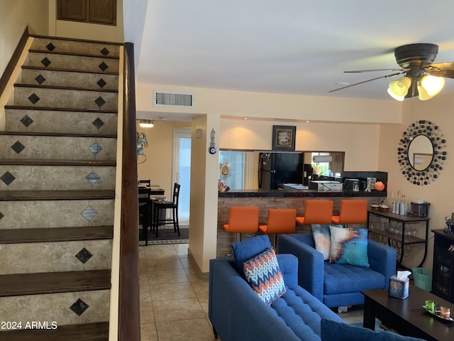 tiled living room with ceiling fan