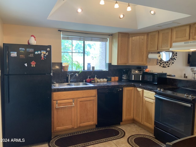 kitchen with sink, black appliances, ventilation hood, a tray ceiling, and decorative backsplash