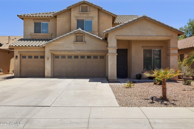 46141 W Rainbow Dr, Maricopa, AZ 85139 - view of front of property featuring concrete driveway, stucco siding, a tile roof, and an attached garage