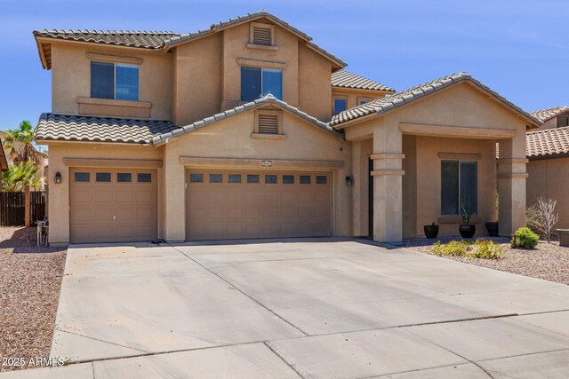 46141 W Rainbow Dr, Maricopa, AZ 85139 - mediterranean / spanish home with a tile roof, stucco siding, driveway, and an attached garage