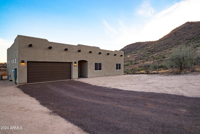 southwest-style home with a mountain view and a garage