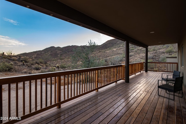 wooden deck with a mountain view