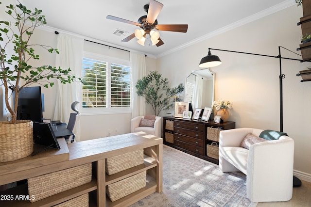 sitting room with visible vents, crown molding, ceiling fan, and wood finished floors