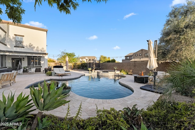 view of pool featuring an in ground hot tub, a fenced in pool, a fenced backyard, a patio, and a fire pit