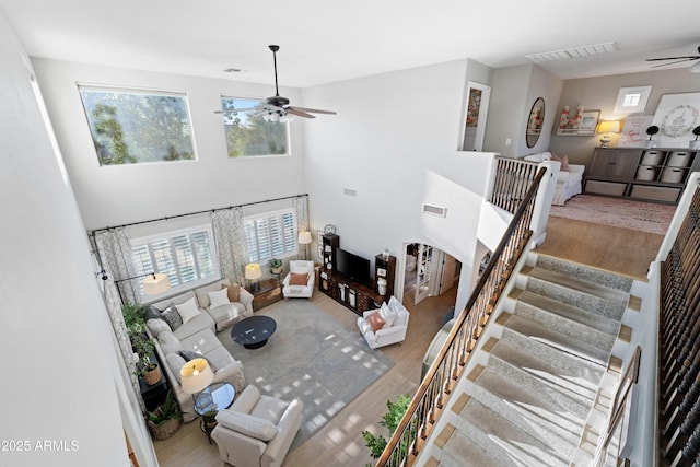 living room featuring a ceiling fan, wood finished floors, and visible vents