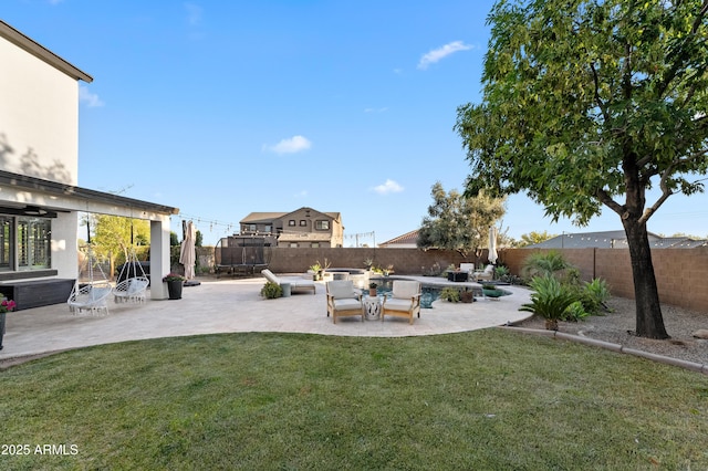view of yard with a patio, a fenced backyard, a trampoline, and an outdoor hangout area