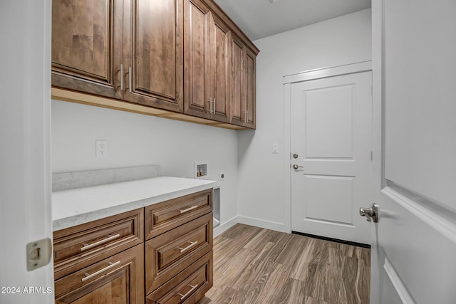 washroom with cabinets, hookup for a washing machine, hardwood / wood-style flooring, and hookup for an electric dryer