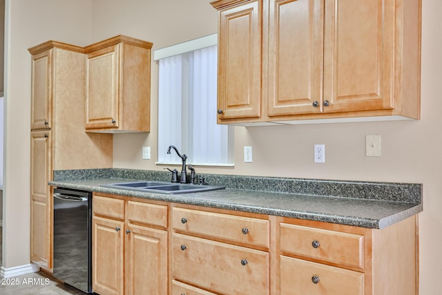 kitchen with dark countertops, light brown cabinets, and a sink