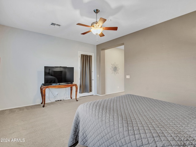 carpeted bedroom with a ceiling fan and visible vents