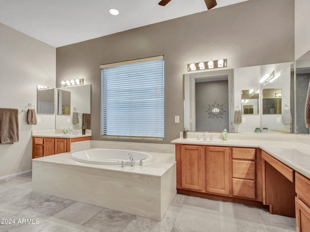 bathroom with ceiling fan, a bath, and vanity