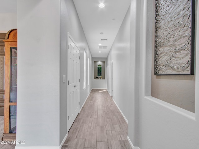 hallway with light wood-type flooring