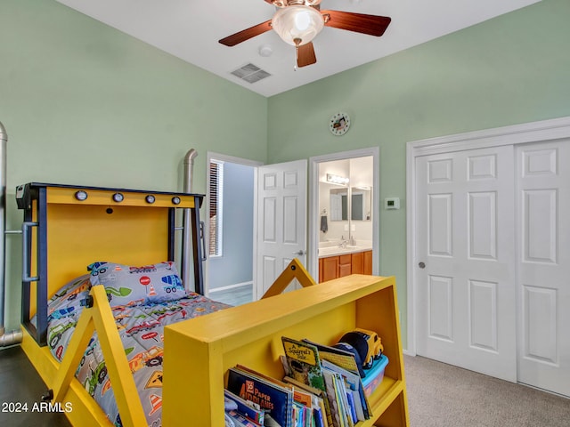 carpeted bedroom featuring ceiling fan, visible vents, a closet, and ensuite bathroom