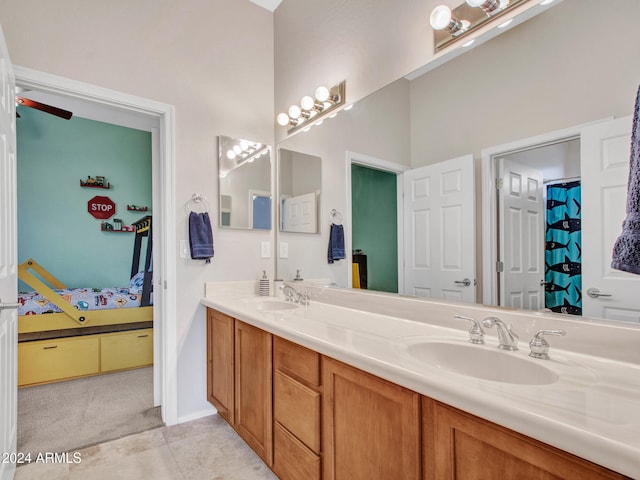 bathroom featuring connected bathroom, tile patterned floors, a sink, and double vanity