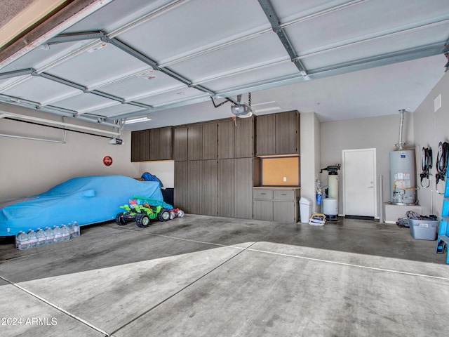 garage with a garage door opener and gas water heater