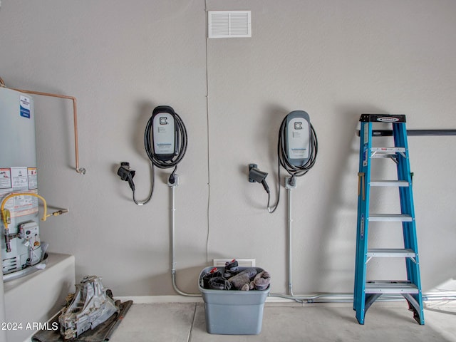 miscellaneous room featuring water heater and visible vents