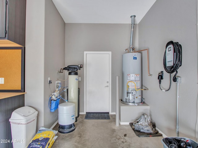 garage featuring water heater and baseboards