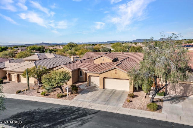 view of front of home with a mountain view and a garage