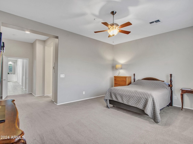 carpeted bedroom with baseboards, visible vents, and a ceiling fan