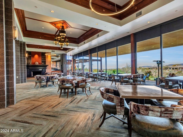 carpeted dining room featuring an inviting chandelier and a tray ceiling