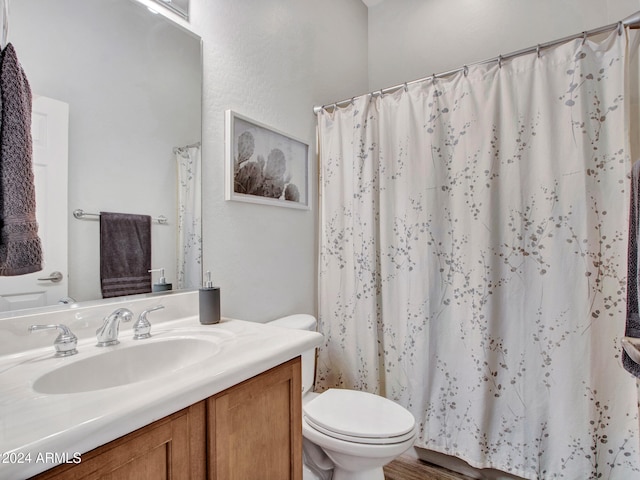 bathroom featuring vanity, toilet, and wood-type flooring