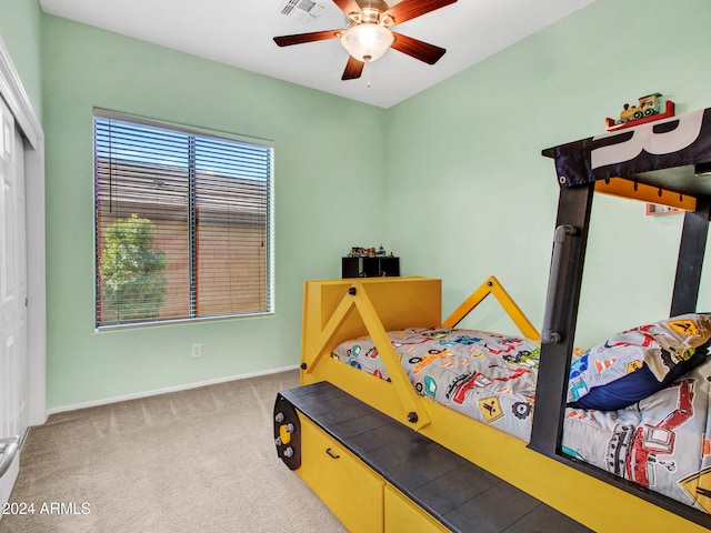 carpeted bedroom with baseboards, visible vents, ceiling fan, and a closet