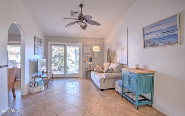 interior space with lofted ceiling, light tile patterned floors, a healthy amount of sunlight, and ceiling fan