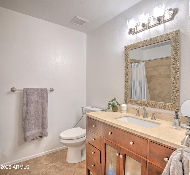 bathroom featuring vanity, curtained shower, tile patterned floors, and toilet