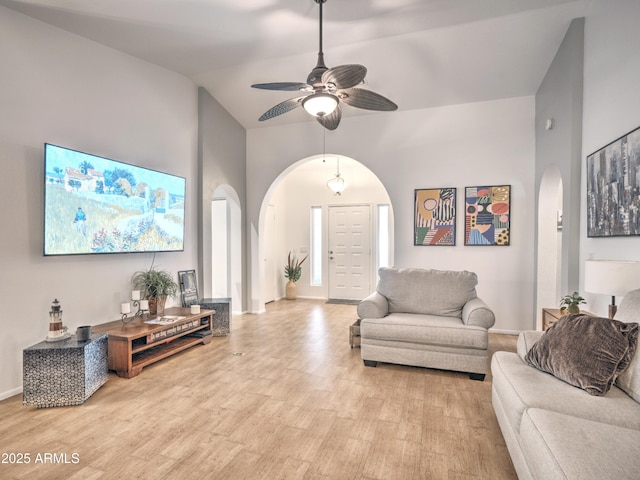 living room featuring vaulted ceiling, ceiling fan, and light hardwood / wood-style floors