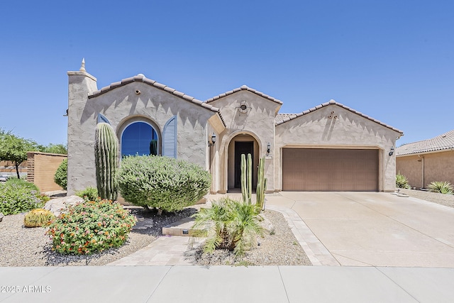 27413 W Tonopah Dr, Buckeye, AZ 85396 - mediterranean / spanish-style home with a garage, stucco siding, and concrete driveway