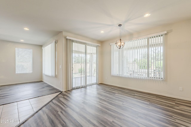 27413 W Tonopah Dr, Buckeye, AZ 85396 - unfurnished dining area with a chandelier, wood finished floors, recessed lighting, and baseboards