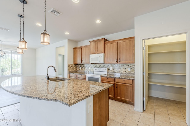 27413 W Tonopah Dr, Buckeye, AZ 85396 - kitchen with white appliances, a sink, light tile patterned floors, decorative backsplash, and brown cabinetry
