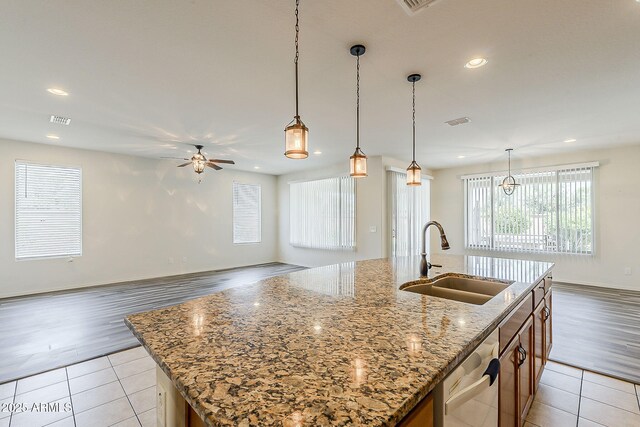 27413 W Tonopah Dr, Buckeye, AZ 85396 - kitchen with a sink, dishwasher, a ceiling fan, light tile patterned floors, and a kitchen island with sink