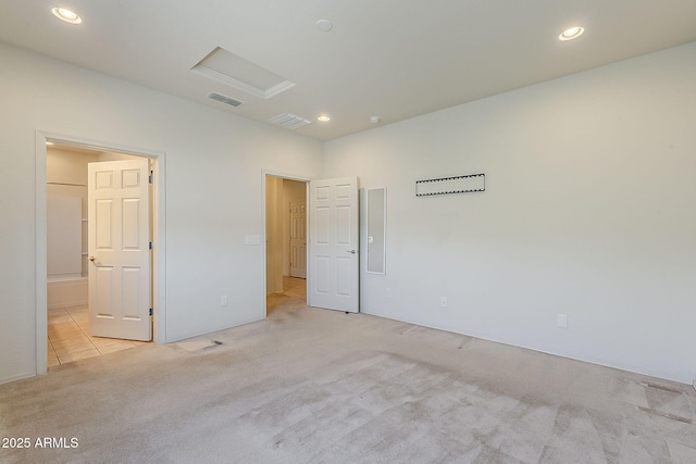 27413 W Tonopah Dr, Buckeye, AZ 85396 - unfurnished bedroom featuring attic access, light colored carpet, recessed lighting, and ensuite bathroom