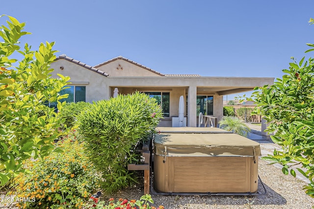27413 W Tonopah Dr, Buckeye, AZ 85396 - rear view of house with a hot tub, stucco siding, and fence