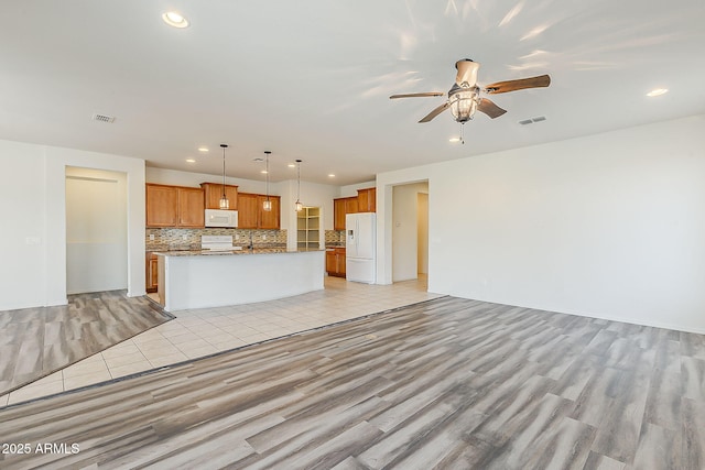 27413 W Tonopah Dr, Buckeye, AZ 85396 - unfurnished living room featuring recessed lighting, a ceiling fan, and light wood-style flooring