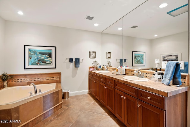 3801 N Goldwater Blvd Unit 201, Scottsdale, AZ 85251 - full bath with double vanity, a garden tub, tile patterned flooring, recessed lighting, and baseboards