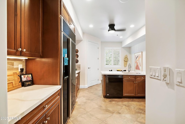 3801 N Goldwater Blvd Unit 201, Scottsdale, AZ 85251 - kitchen featuring black dishwasher, a sink, light countertops, brown cabinets, and ceiling fan