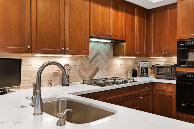 3801 N Goldwater Blvd Unit 201, Scottsdale, AZ 85251 - kitchen featuring a sink, oven, backsplash, and stainless steel gas stovetop