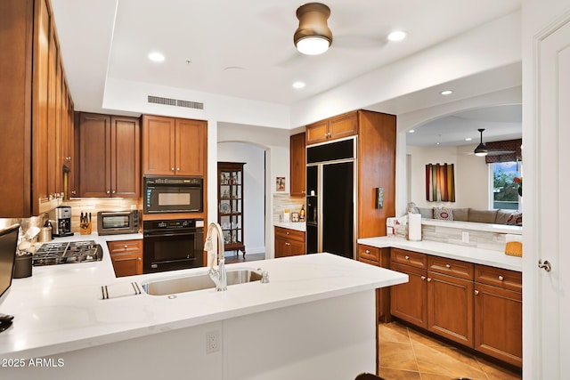 3801 N Goldwater Blvd Unit 201, Scottsdale, AZ 85251 - kitchen with oven, arched walkways, paneled built in fridge, a peninsula, and recessed lighting