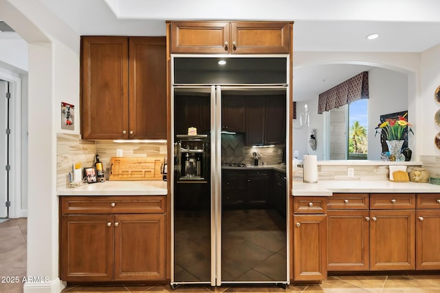 3801 N Goldwater Blvd Unit 201, Scottsdale, AZ 85251 - kitchen with decorative backsplash, light countertops, light tile patterned floors, and recessed lighting