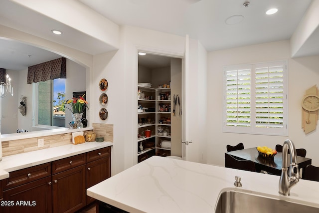3801 N Goldwater Blvd Unit 201, Scottsdale, AZ 85251 - kitchen with a sink, healthy amount of natural light, light stone countertops, and recessed lighting