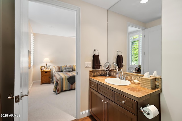 3801 N Goldwater Blvd Unit 201, Scottsdale, AZ 85251 - bathroom featuring vanity, ensuite bathroom, and baseboards