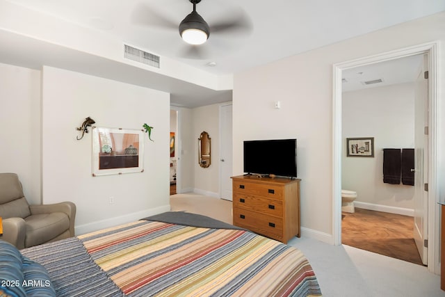 3801 N Goldwater Blvd Unit 201, Scottsdale, AZ 85251 - bedroom with light carpet, baseboards, connected bathroom, and ceiling fan
