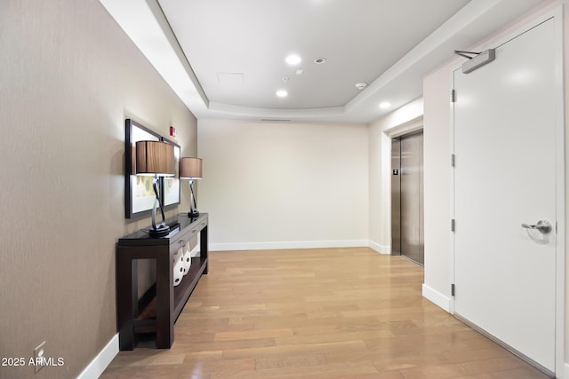 3801 N Goldwater Blvd Unit 201, Scottsdale, AZ 85251 - corridor with light wood-type flooring, a tray ceiling, baseboards, and recessed lighting
