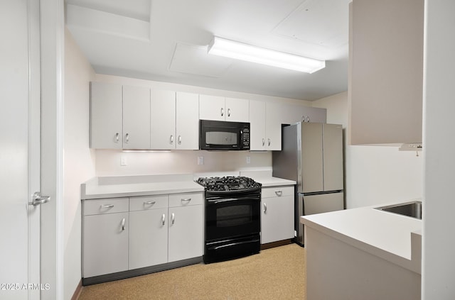 3801 N Goldwater Blvd Unit 201, Scottsdale, AZ 85251 - kitchen featuring black appliances, light countertops, a sink, and white cabinetry