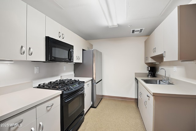3801 N Goldwater Blvd Unit 201, Scottsdale, AZ 85251 - kitchen featuring black appliances, a sink, light countertops, white cabinetry, and baseboards