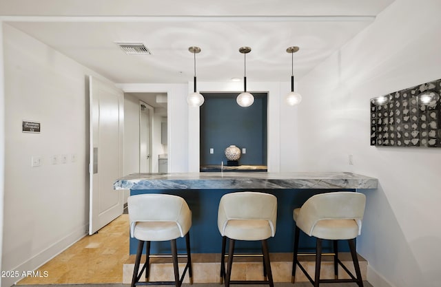 3801 N Goldwater Blvd Unit 201, Scottsdale, AZ 85251 - indoor bar with baseboards and hanging light fixtures