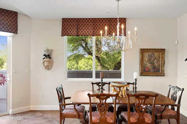 3801 N Goldwater Blvd Unit 201, Scottsdale, AZ 85251 - dining space featuring a chandelier, healthy amount of natural light, and baseboards