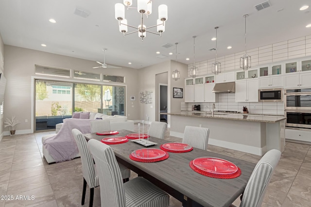 dining space with visible vents, recessed lighting, ceiling fan with notable chandelier, and baseboards